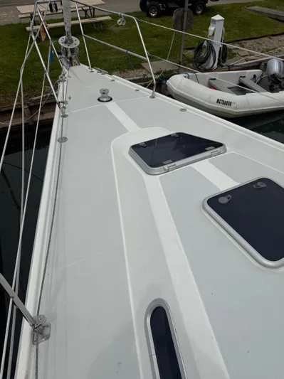 Windquest Yacht Photos Pics 2001 Catalina 42 MkII sailboat deck with hatches, docked near inflatable dinghy.