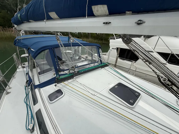 Windquest Yacht Photos Pics 2001 Catalina 42 MkII sailboat with blue canopy and rigging, docked in a marina.