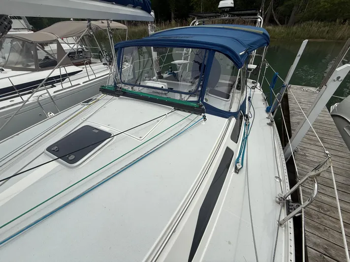 Windquest Yacht Photos Pics 2001 Catalina 42 MkII sailboat docked, featuring a blue canopy and sleek deck design.