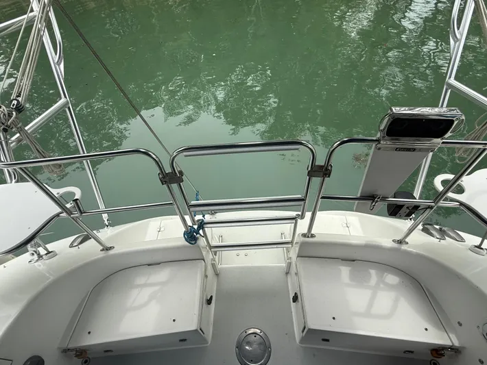 Windquest Yacht Photos Pics Stern view of 2001 Catalina 42 MkII sailboat with railing and calm water.