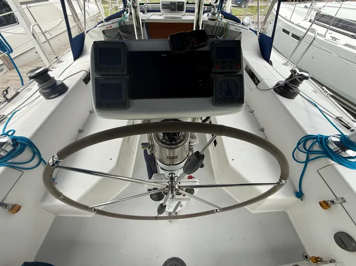 Windquest Yacht Photos Pics Cockpit of 2001 Catalina 42 MkII sailboat with steering wheel and navigation instruments.