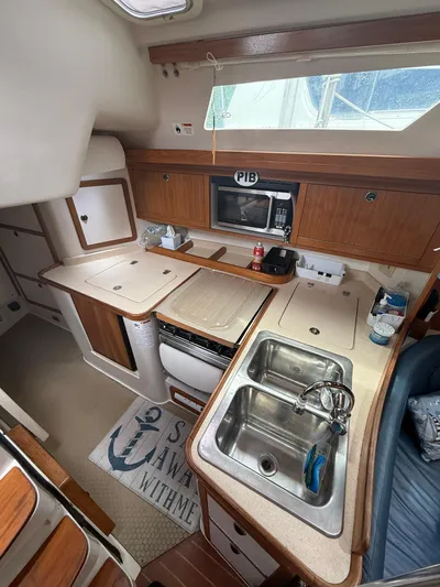 Windquest Yacht Photos Pics Interior of 2001 Catalina 42 MkII sailboat featuring a compact kitchen area.