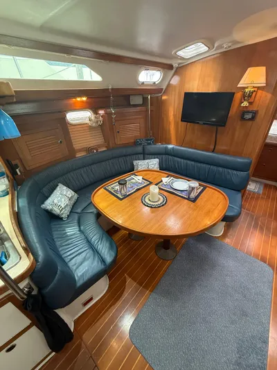 Windquest Yacht Photos Pics Interior of 2001 Catalina 42 MkII sailboat with cozy seating and wooden table.