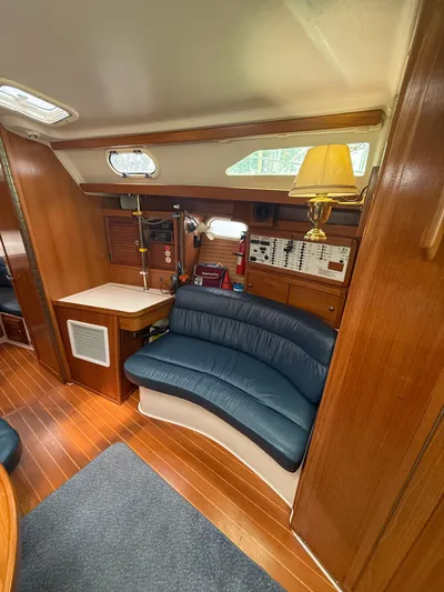Windquest Yacht Photos Pics Interior of 2001 Catalina 42 MkII sailboat with blue seating and wooden finishes.