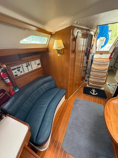 Windquest Yacht Photos Pics Interior of 2001 Catalina 42 MkII sailboat with blue seating and wooden accents.