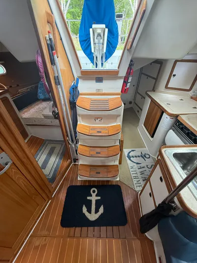 Windquest Yacht Photos Pics Interior of 2001 Catalina 42 MkII sailboat with wooden flooring and nautical decor.