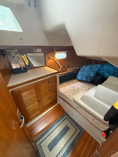 Windquest Yacht Photos Pics 2001 Catalina 42 MkII cabin interior with bed, storage, and window.