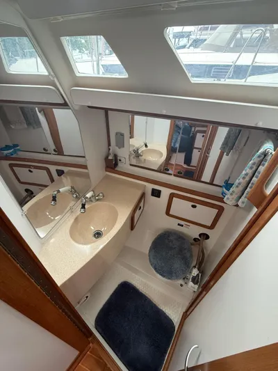 Windquest Yacht Photos Pics Bathroom interior of a 2001 Catalina 42 MkII sailboat with sink and mirror.