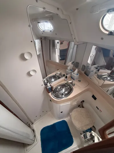 Windquest Yacht Photos Pics 2001 Catalina 42 MkII yacht bathroom with sink, mirror, and porthole.