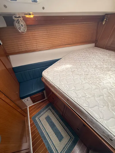 Windquest Yacht Photos Pics 2001 Catalina 42 MkII cabin interior with bed, blue seating, and wooden accents.