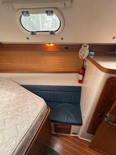 Windquest Yacht Photos Pics Interior of 2001 Catalina 42 MkII sailboat cabin with bed, seating, and porthole.
