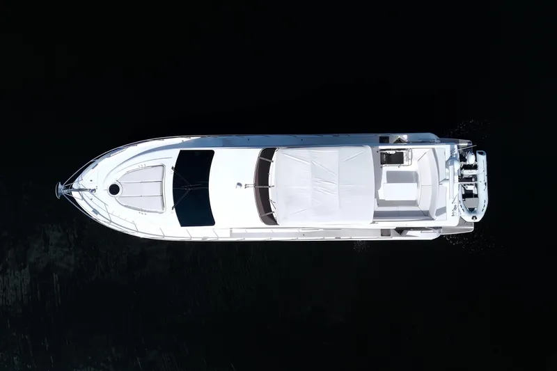 Wanderlust Yacht Photos Pics Aerial view of 2015 Dyna 60 yacht on dark water.
