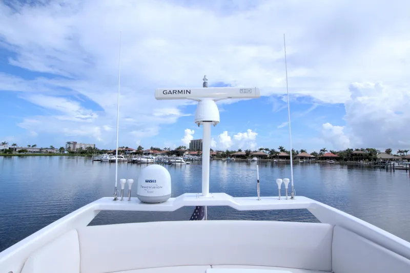 Wanderlust Yacht Photos Pics 2015 Dyna 60 yacht with Garmin radar, serene waterfront view, clear blue sky.