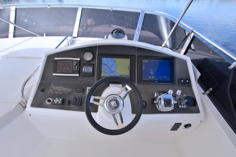Wanderlust Yacht Photos Pics Cockpit of 2015 Dyna 60 yacht with navigation screens and steering wheel.