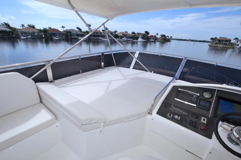 Wanderlust Yacht Photos Pics Helm of 2015 Dyna 60 yacht with waterfront view and modern controls.