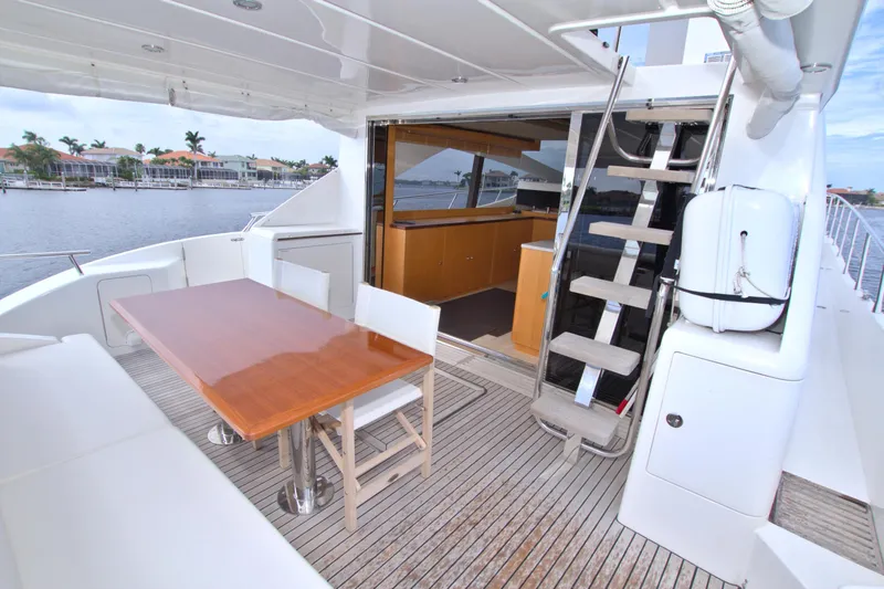 Wanderlust Yacht Photos Pics Luxury Dyna 60 yacht deck with dining area and stairs, 2015 model.