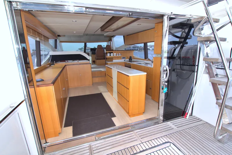 Wanderlust Yacht Photos Pics Luxurious interior of 2015 Dyna 60 yacht with modern wooden cabinetry and sleek design.