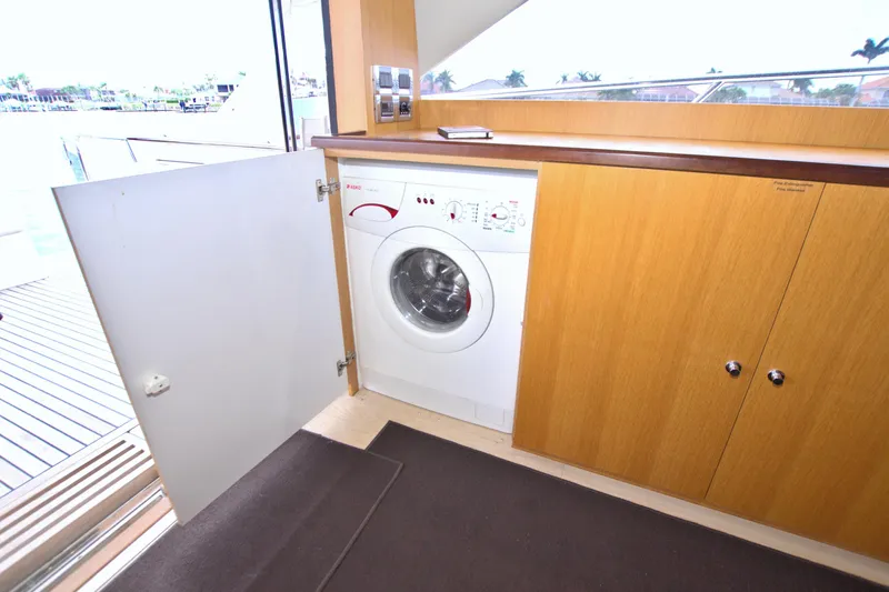 Wanderlust Yacht Photos Pics Laundry area on a 2015 Dyna 60 yacht with a washing machine.