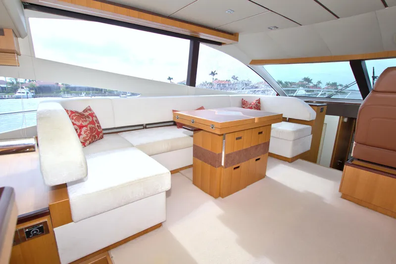 Wanderlust Yacht Photos Pics Luxurious interior of 2015 Dyna 60 yacht with elegant seating and wooden accents.