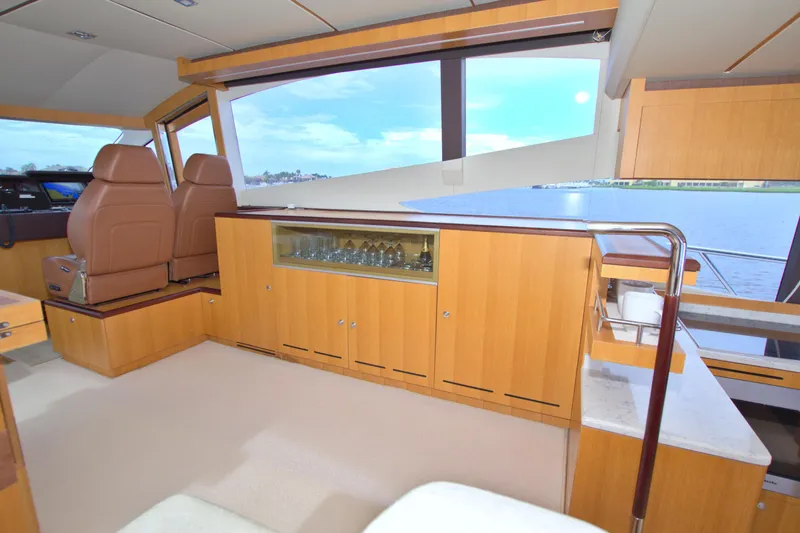 Wanderlust Yacht Photos Pics Luxurious interior of 2015 Dyna 60 yacht with elegant wood cabinetry and panoramic windows.