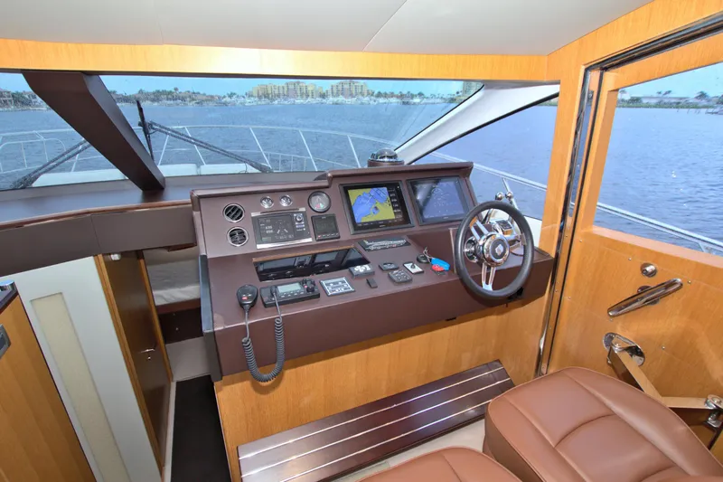 Wanderlust Yacht Photos Pics Helm of 2015 Dyna 60 yacht with navigation equipment and leather seating.