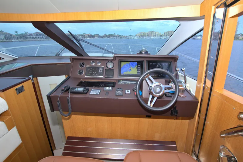 Wanderlust Yacht Photos Pics Helm of 2015 Dyna 60 yacht with navigation equipment and steering wheel.