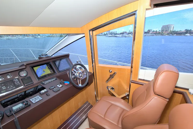 Wanderlust Yacht Photos Pics Helm of 2015 Dyna 60 yacht with navigation screens and leather captain's chair.