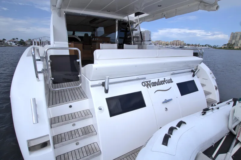 Wanderlust Yacht Photos Pics Luxury yacht Dyna 60, 2015 model, docked with inflatable boat, rear view.