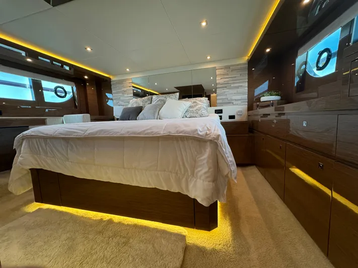 The 7 C's Yacht Photos Pics Luxurious bedroom interior of 2021 Cruisers Yachts 60 Cantius Flybridge with modern lighting.