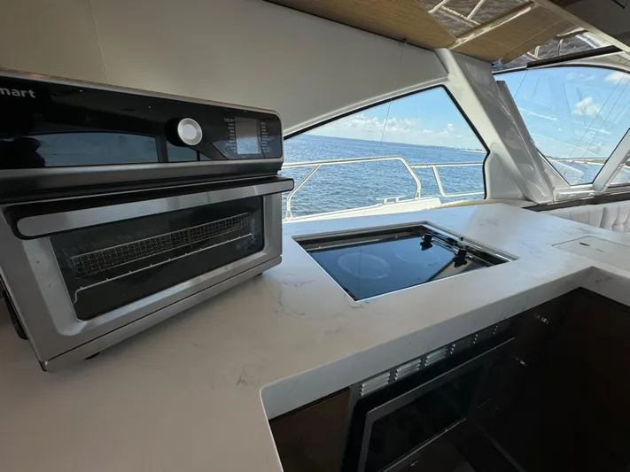 The 7 C's Yacht Photos Pics Modern kitchen on 2021 Cruisers Yachts 60 Cantius Flybridge with ocean view.