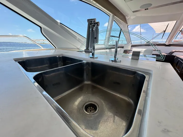 The 7 C's Yacht Photos Pics Luxurious kitchen sink on 2021 Cruisers Yachts 60 Cantius Flybridge with ocean view.