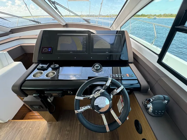 The 7 C's Yacht Photos Pics Helm of 2021 Cruisers Yachts 60 Cantius Flybridge with modern navigation displays.