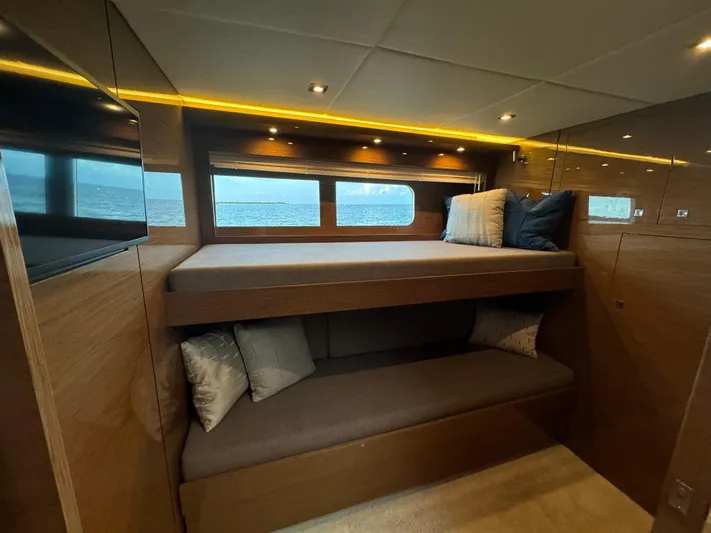 The 7 C's Yacht Photos Pics Luxurious 2021 Cruisers Yachts 60 Cantius Flybridge cabin with cozy bunk beds and ocean view.