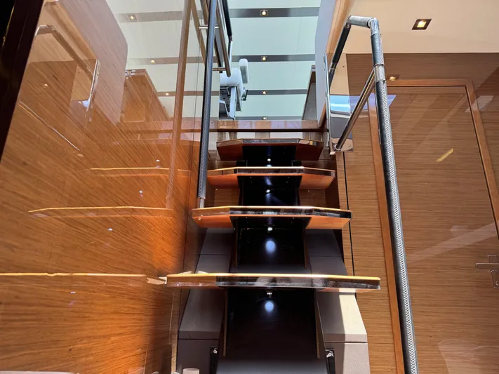 The 7 C's Yacht Photos Pics Staircase on 2021 Cruisers Yachts 60 Cantius Flybridge with sleek wood and metal design.