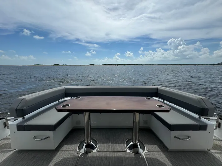 The 7 C's Yacht Photos Pics 2021 Cruisers Yachts 60 Cantius Flybridge, rear seating area with ocean view.