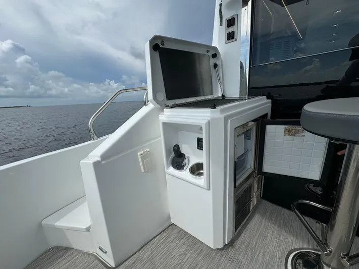 The 7 C's Yacht Photos Pics 2021 Cruisers Yachts 60 Cantius Flybridge outdoor kitchenette with ocean view.