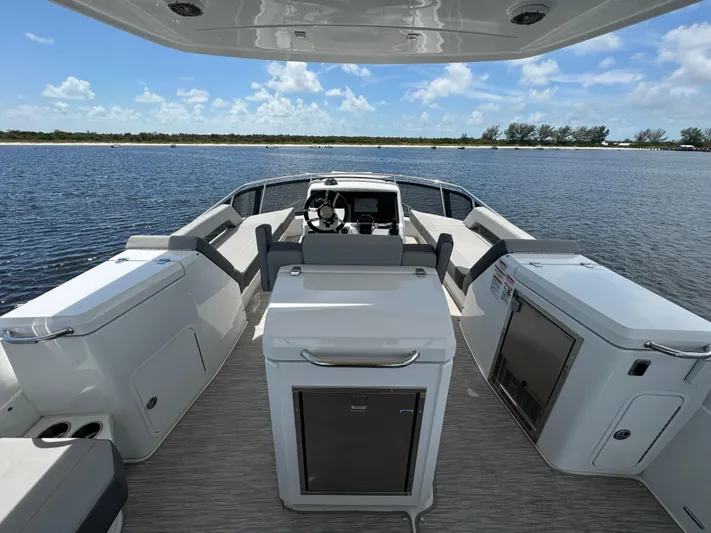 The 7 C's Yacht Photos Pics 2021 Cruisers Yachts 60 Cantius Flybridge interior with helm, seating, and water view.