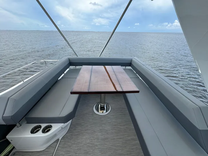 The 7 C's Yacht Photos Pics 2021 Cruisers Yachts 60 Cantius Flybridge, elegant seating area with ocean view.