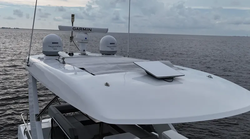 The 7 C's Yacht Photos Pics 2021 Cruisers Yachts 60 Cantius Flybridge on open water, featuring advanced Garmin navigation.