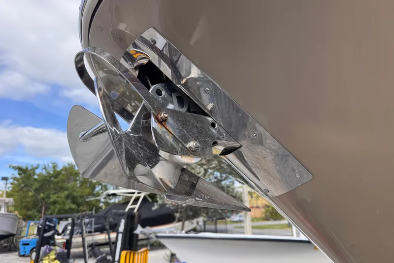  Yacht Photos Pics Close-up of 2014 Chris-Craft Launch 28 boat propeller, shiny metal finish, outdoor setting.