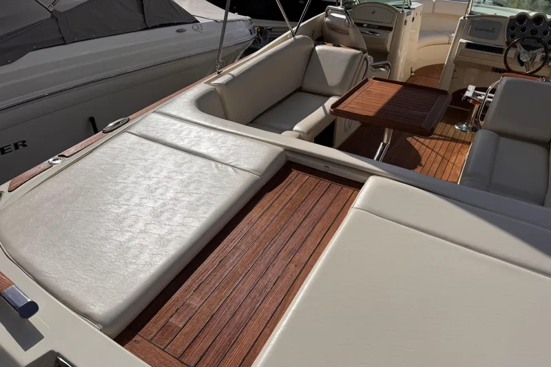  Yacht Photos Pics 2014 Chris-Craft Launch 28 interior with teak flooring and cushioned seating.