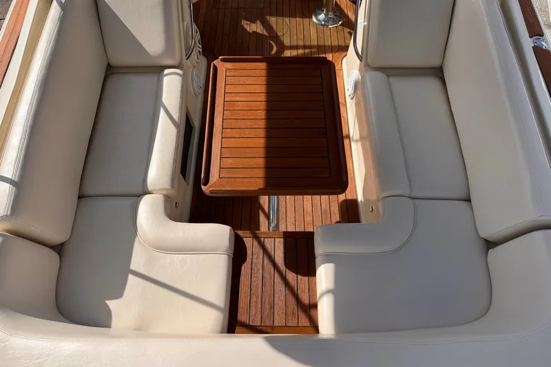  Yacht Photos Pics 2014 Chris-Craft Launch 28 interior with beige seating and wooden table.