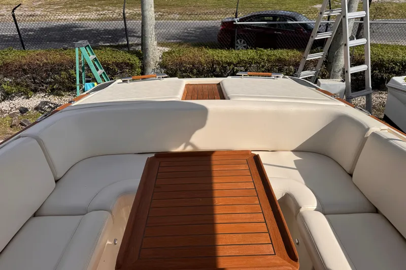  Yacht Photos Pics 2014 Chris-Craft Launch 28 boat interior with wooden table and white seating.