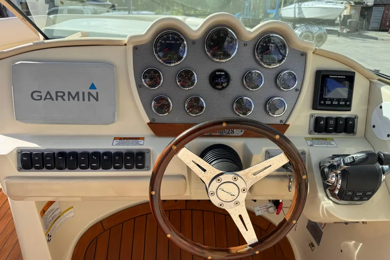  Yacht Photos Pics 2014 Chris-Craft Launch 28 dashboard with Garmin navigation and wooden steering wheel.