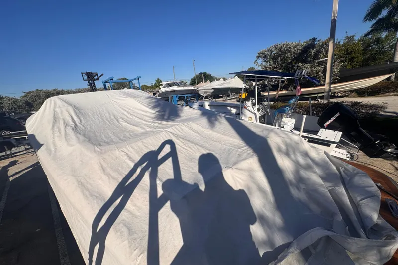  Yacht Photos Pics Covered 2014 Chris-Craft Launch 28 boat in a sunny outdoor storage area.