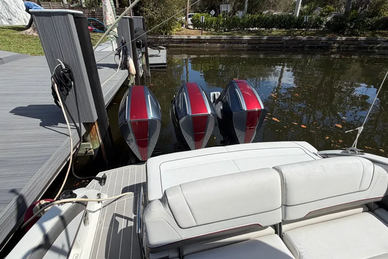  Yacht Photos Pics 2020 Formula 330 Crossover Bowrider OB with triple outboard engines docked by the water.