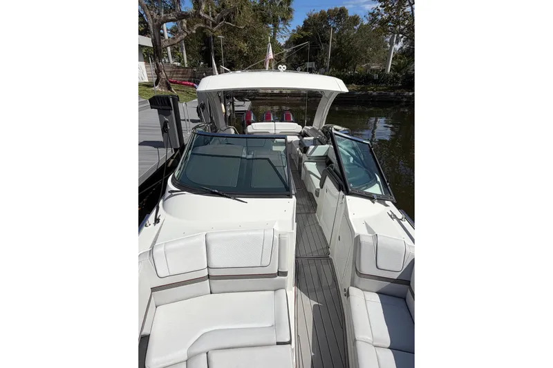  Yacht Photos Pics 2020 Formula 330 Crossover Bowrider OB, sleek design, docked on calm water.