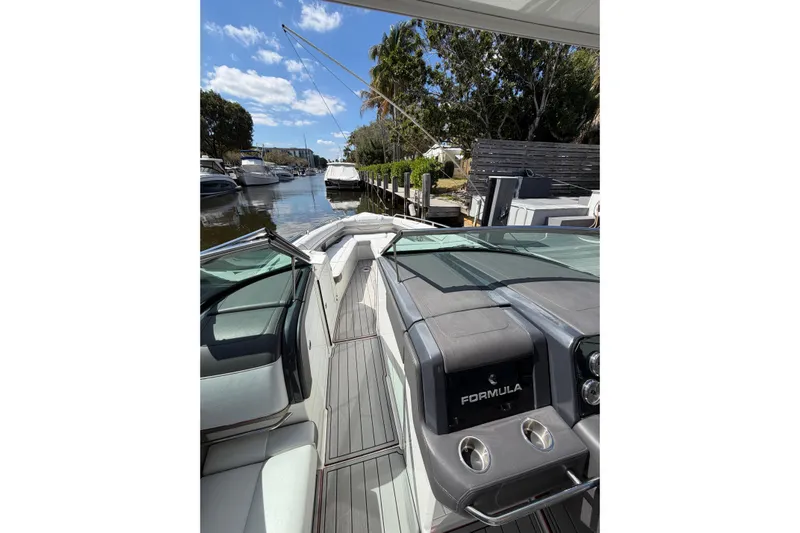  Yacht Photos Pics 2020 Formula 330 Crossover Bowrider OB interior, docked in a scenic marina.