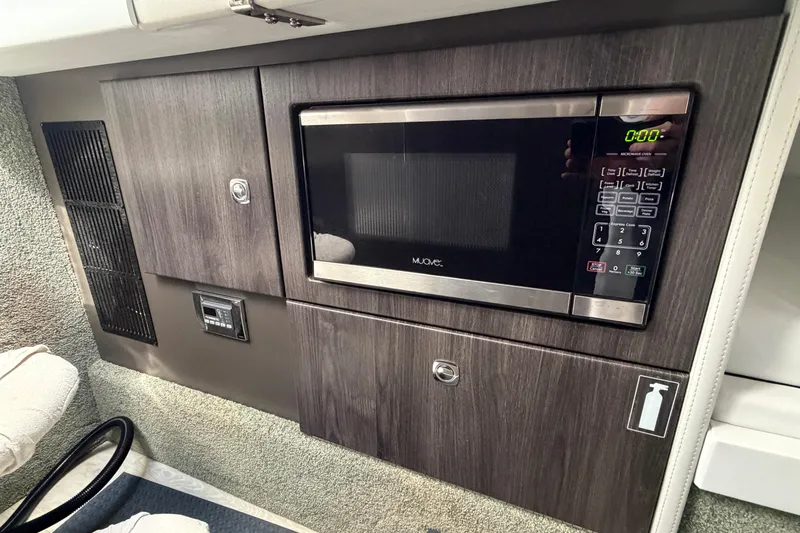  Yacht Photos Pics 2020 Formula 330 Crossover Bowrider OB interior with built-in microwave and storage cabinets.