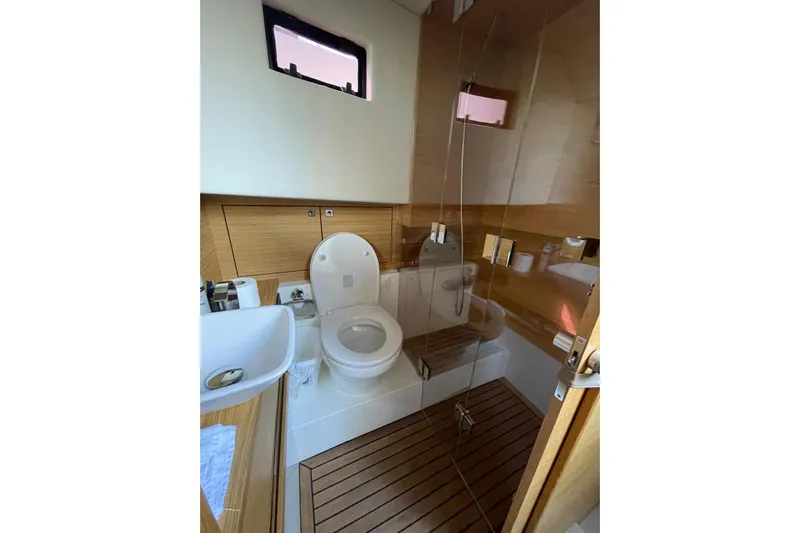  Yacht Photos Pics Luxurious 2021 De Antonio Yachts Express bathroom with modern fixtures and wooden accents.